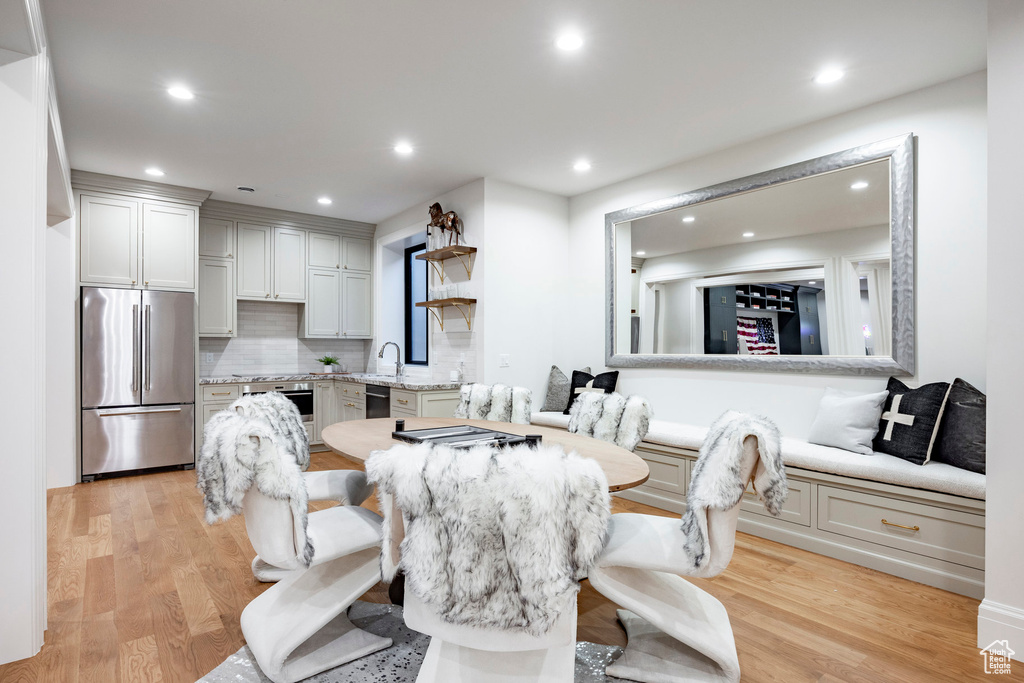 Dining area with light wood-type flooring and recessed lighting