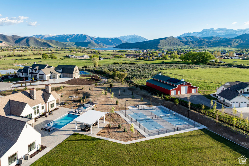 View of rural area with a mountain backdrop and a pool area