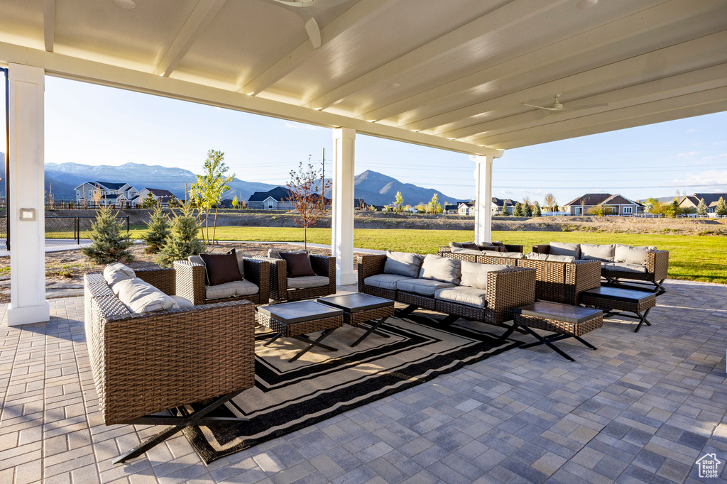 View of patio / terrace featuring an outdoor hangout area, a mountain view, and ceiling fan