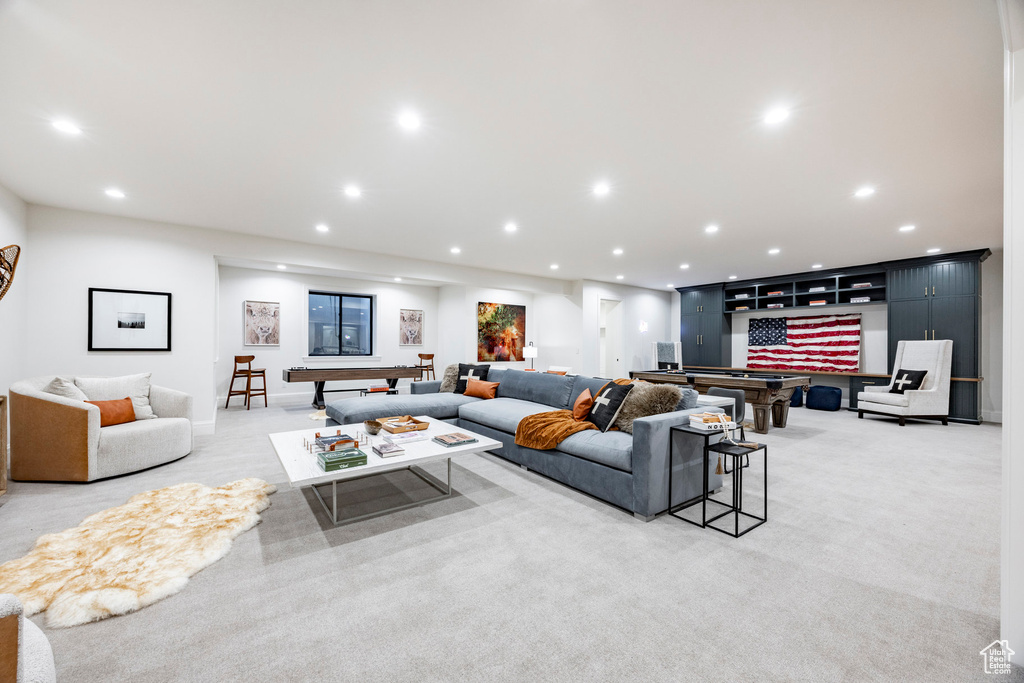Living area featuring recessed lighting and light colored carpet