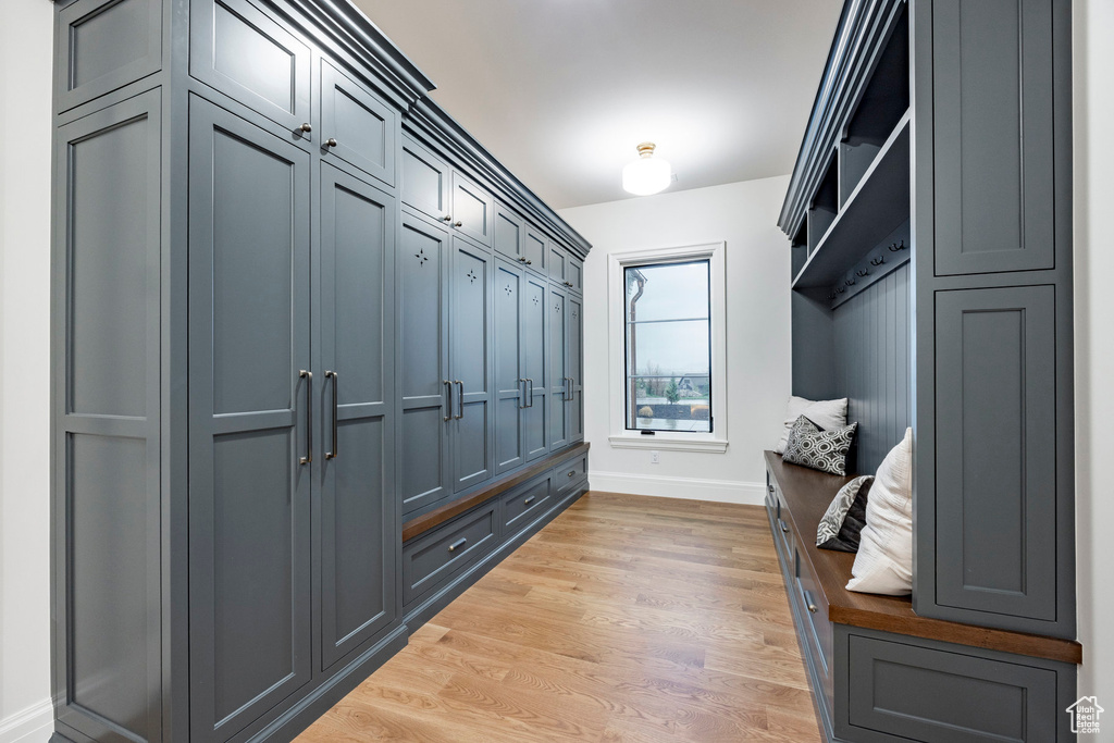 Mudroom with light wood-style floors and baseboards
