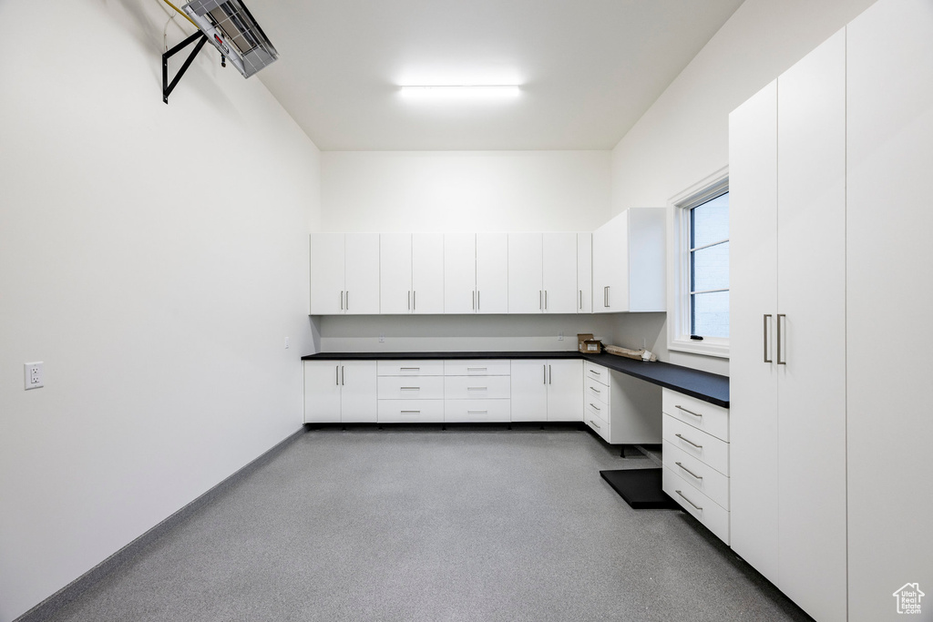 Unfurnished office with built in desk and baseboards