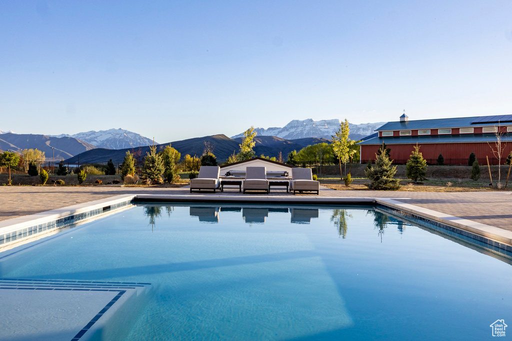 Swimming pool featuring a mountain view and fence