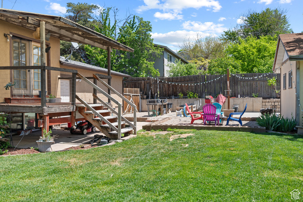 View of yard with a patio area and stairs