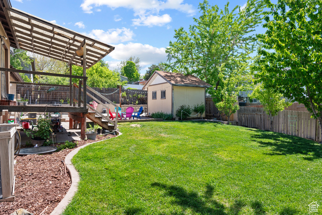 View of yard featuring an outbuilding and a storage shed