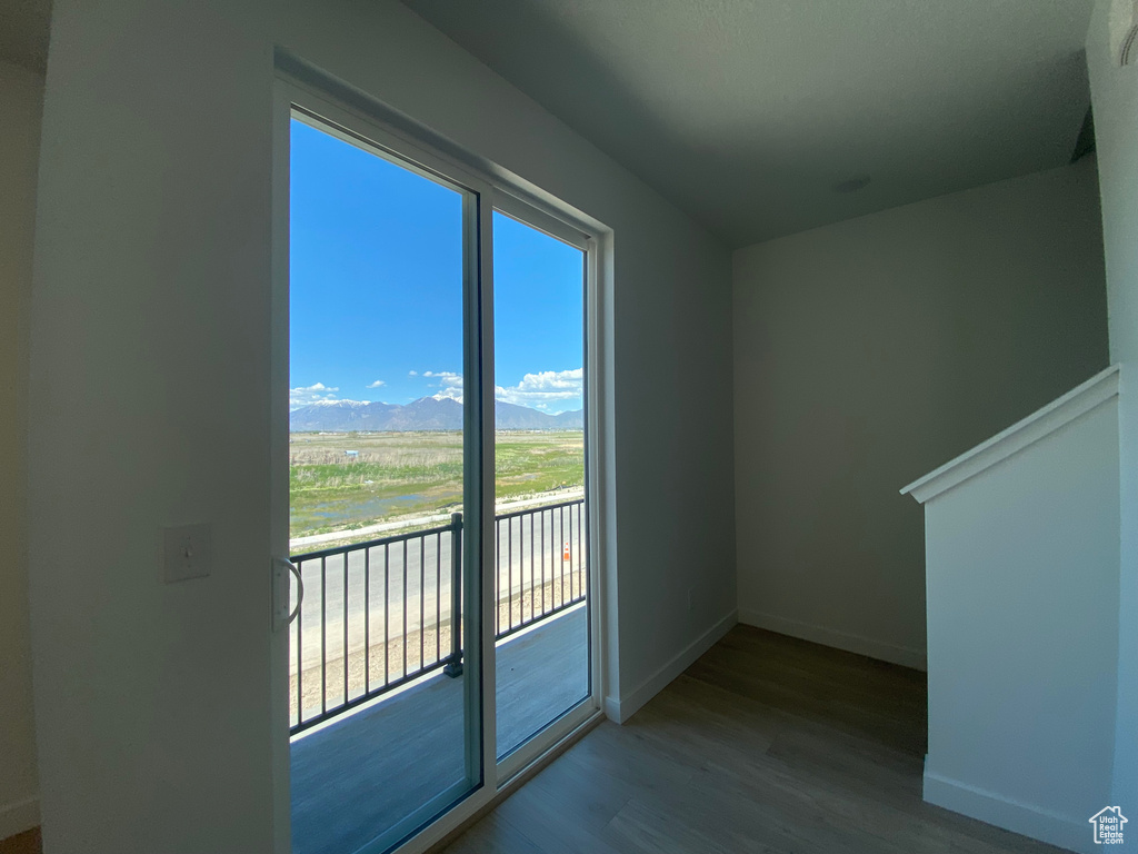 Bonus room featuring a mountain view, wood finished floors, and baseboards