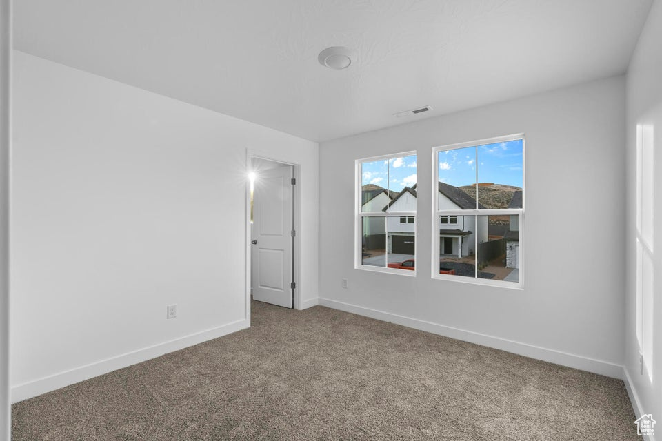 Unfurnished room with carpet floors and baseboards