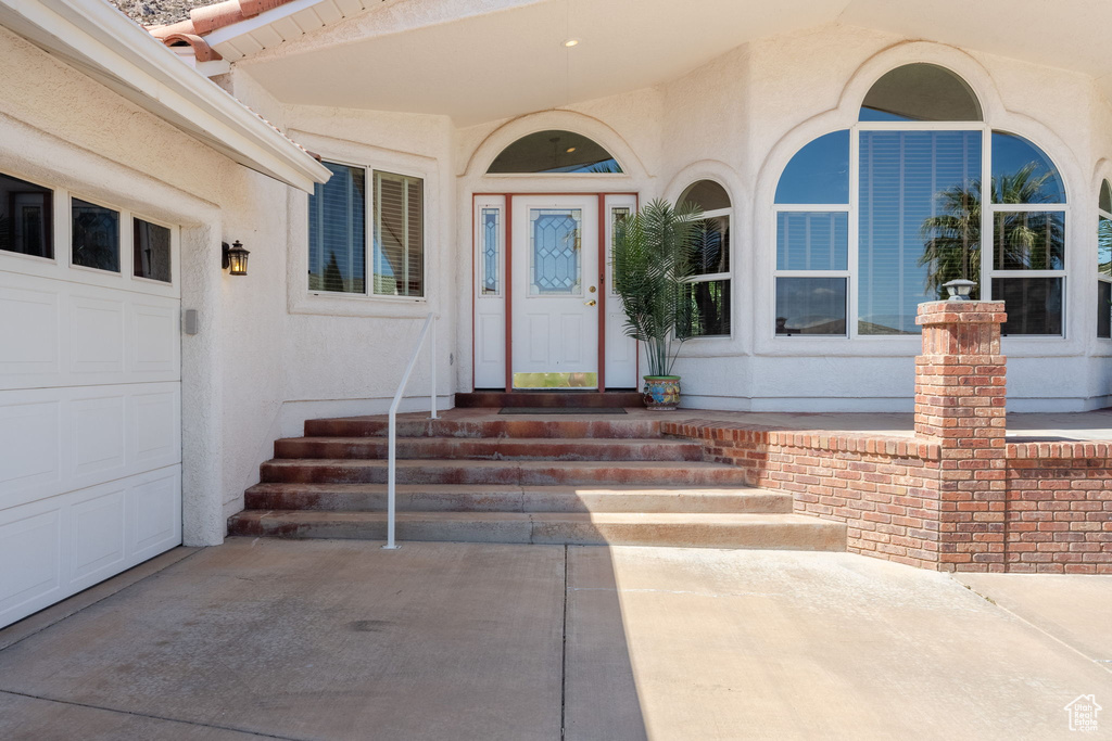 Entrance to property with stucco siding