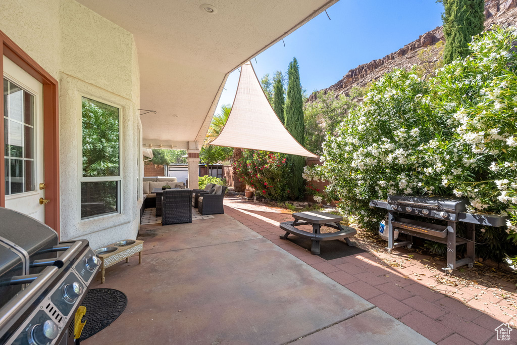 View of patio / terrace featuring a mountain view, an outdoor hangout area, outdoor dining area, and fence