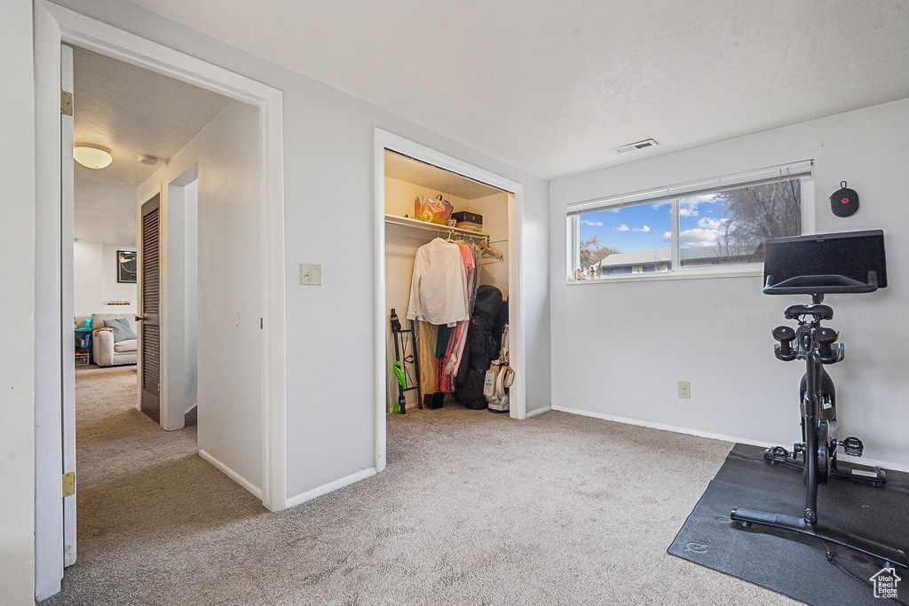 Workout room featuring carpet and baseboards