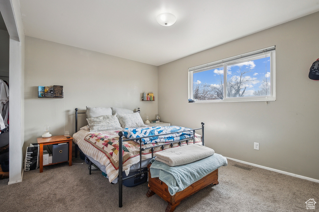 Carpeted bedroom featuring baseboards