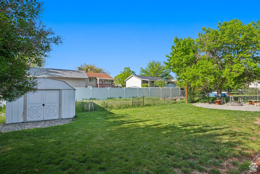 View of yard featuring a storage shed and an outbuilding