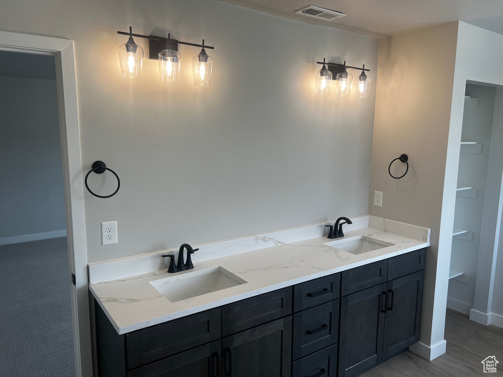 Full bath featuring a sink and baseboards