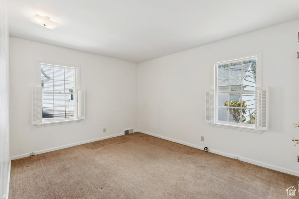 Carpeted empty room with baseboards