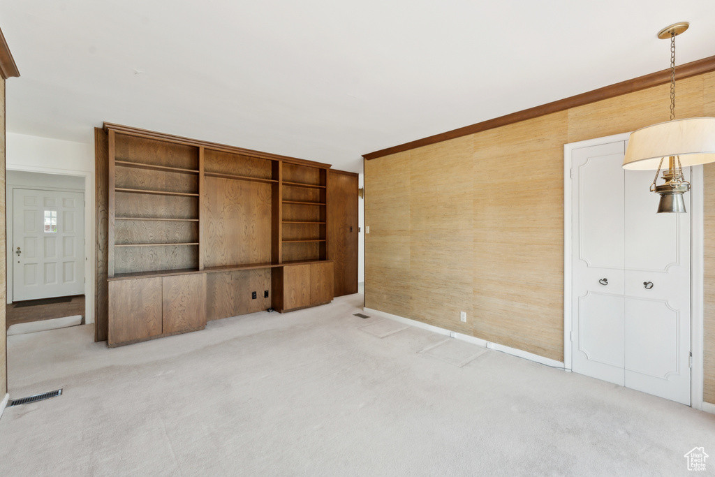 Empty room featuring carpet floors and wood walls