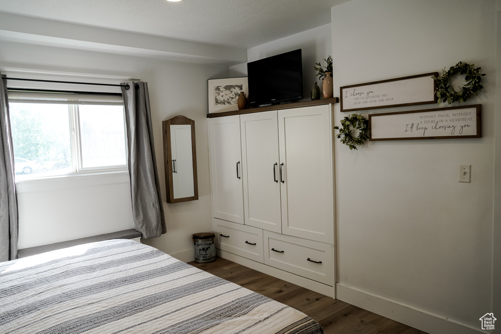 Bedroom featuring dark wood-style floors
