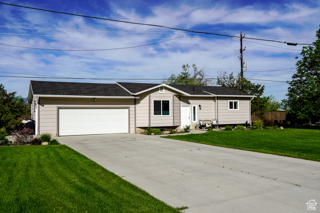 Ranch-style house featuring driveway and a garage