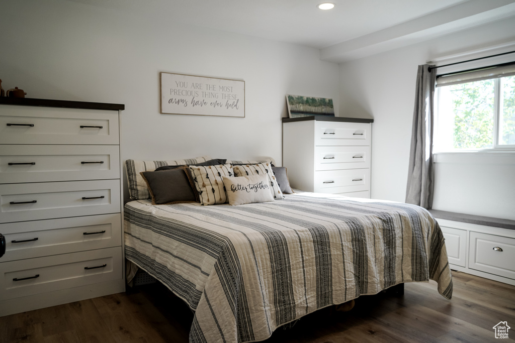 Bedroom with dark wood finished floors and recessed lighting