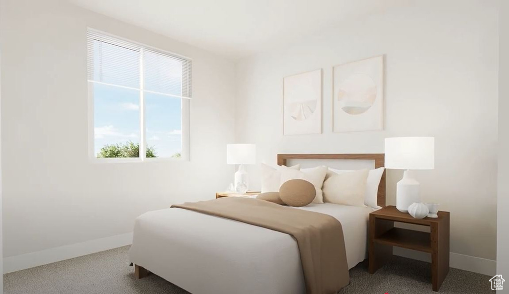 Bedroom featuring baseboards and carpet