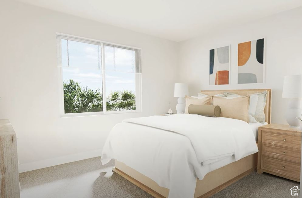 Bedroom with multiple windows, baseboards, and carpet