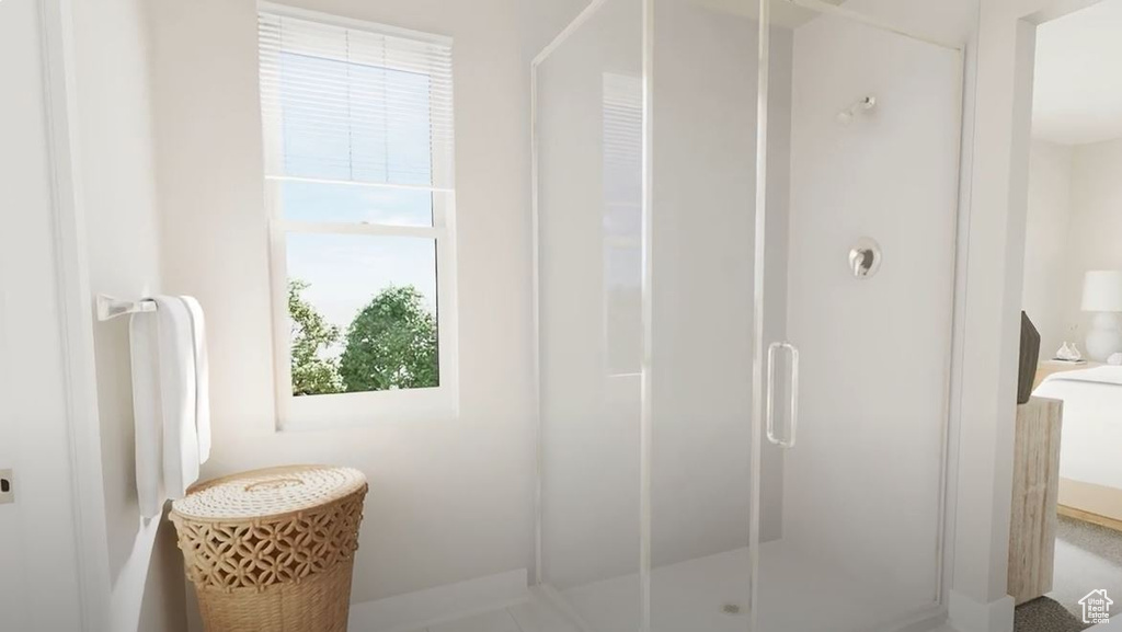 Bathroom featuring a stall shower and baseboards