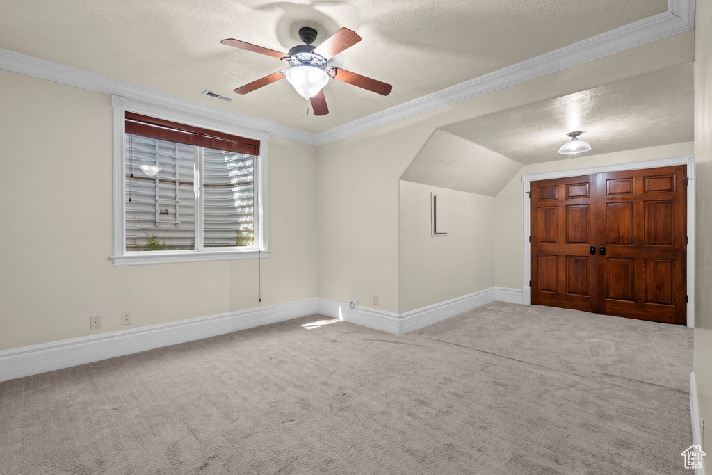 Additional living space with carpet flooring, ceiling fan, and baseboards