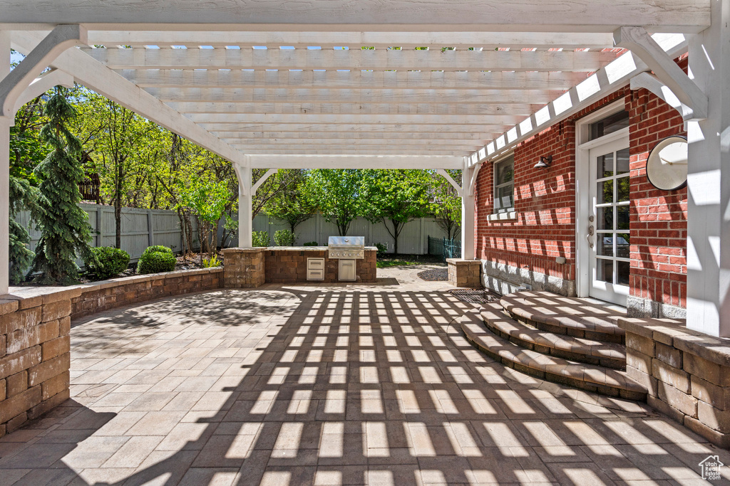 View of patio with a fenced backyard and a pergola