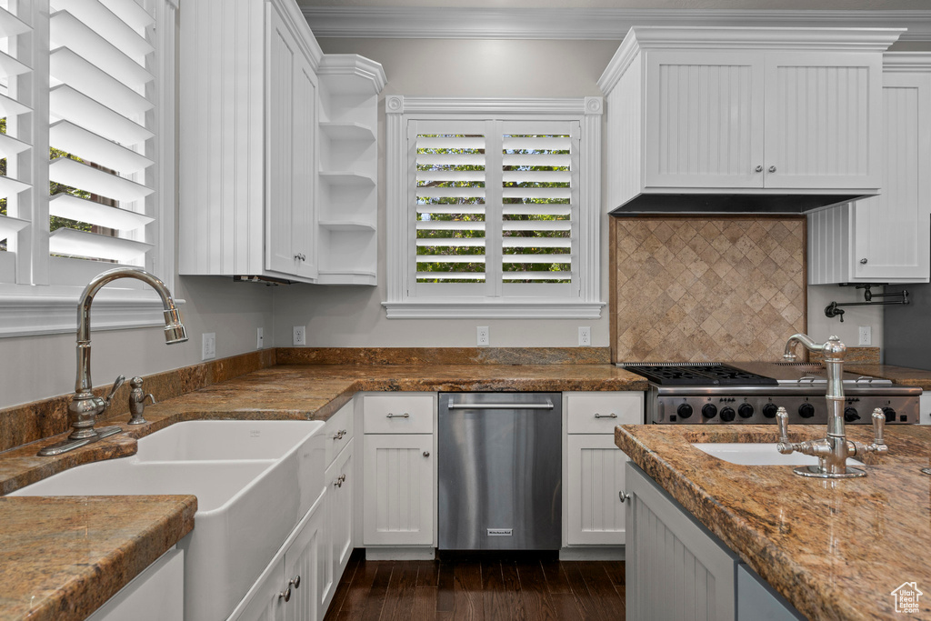Kitchen featuring a sink, ornamental molding, white cabinetry, dark wood-style floors, and dishwasher