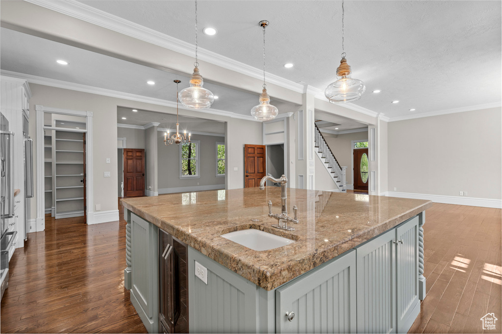 Kitchen featuring a sink, dark wood-style flooring, recessed lighting, a kitchen island with sink, and open floor plan