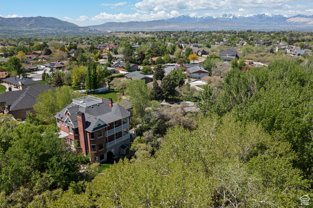 Aerial view of residential area featuring a mountainous background