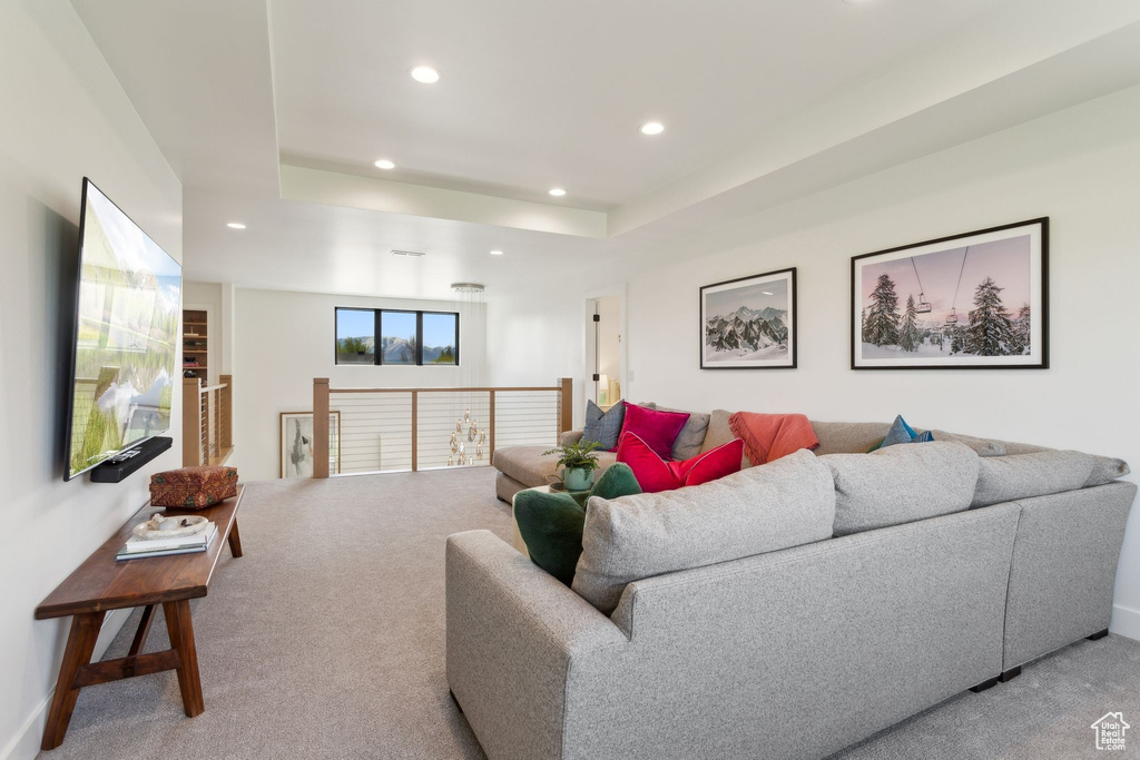 Living room with recessed lighting, light colored carpet, and baseboards
