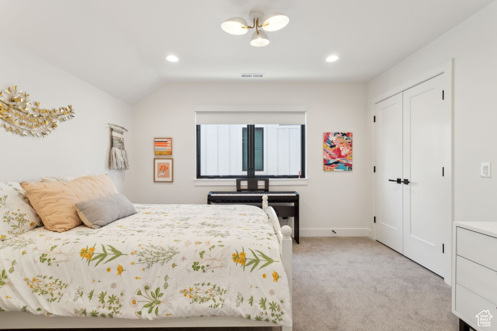 Bedroom with light carpet, recessed lighting, a closet, vaulted ceiling, and baseboards