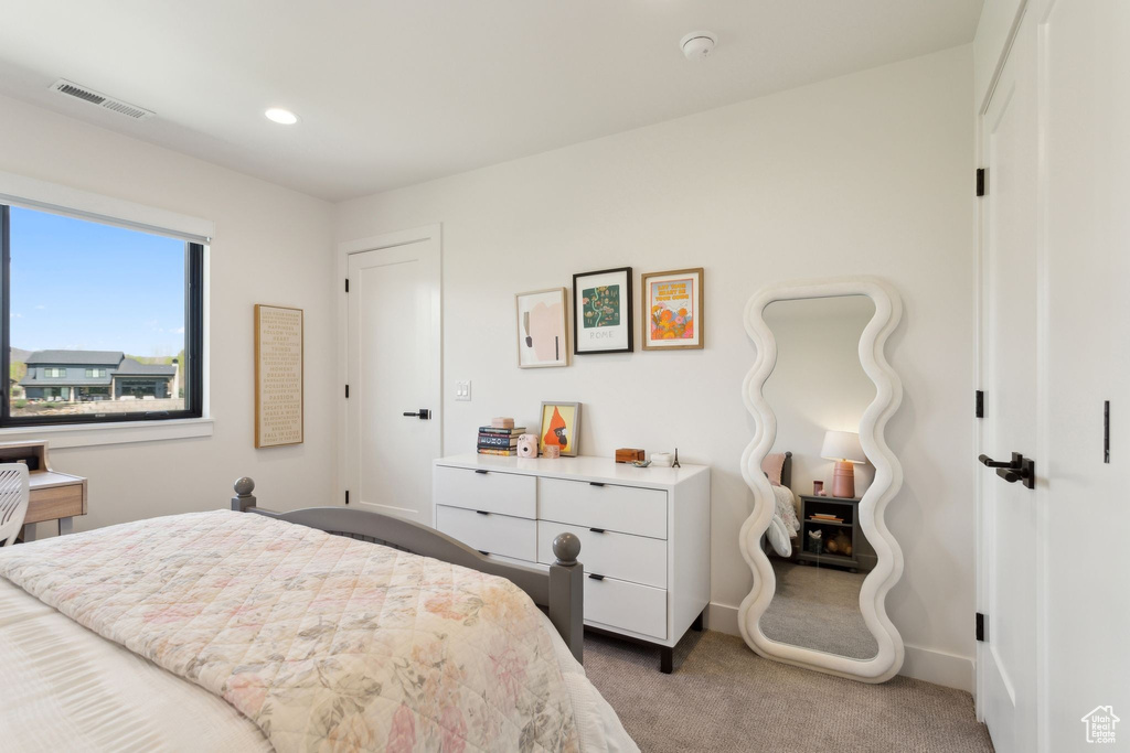 Bedroom featuring light colored carpet, baseboards, and recessed lighting