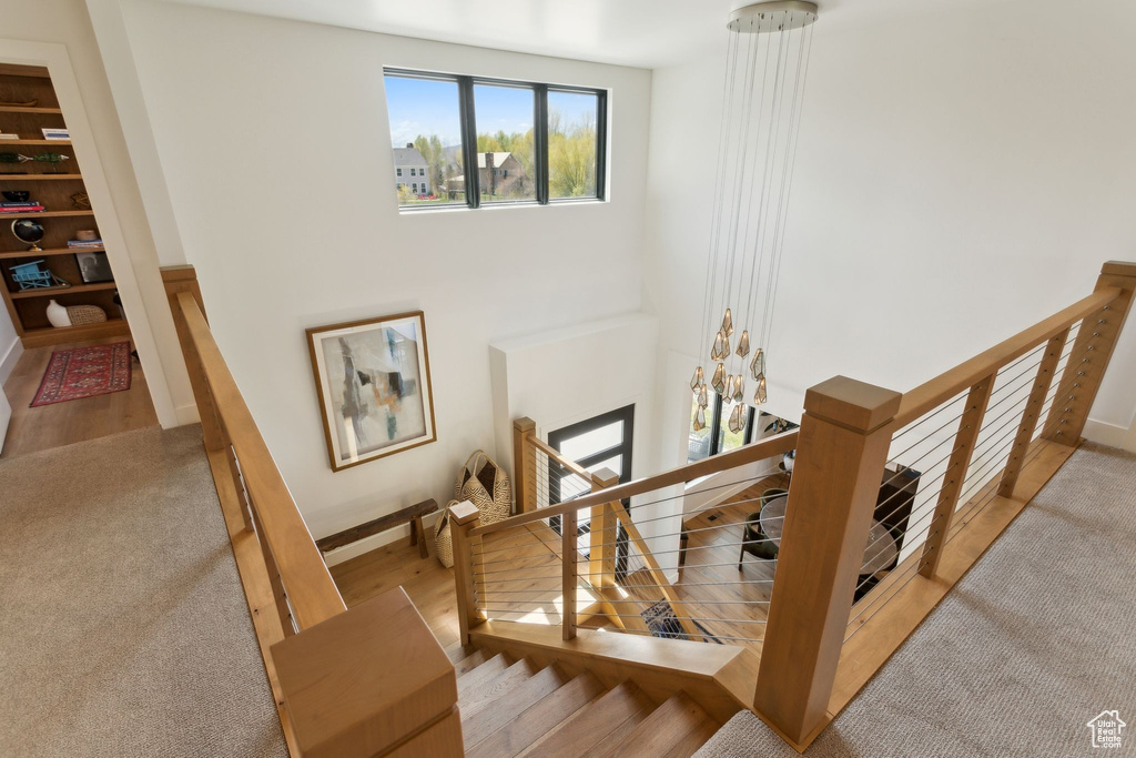 Stairs with wood finished floors and baseboards