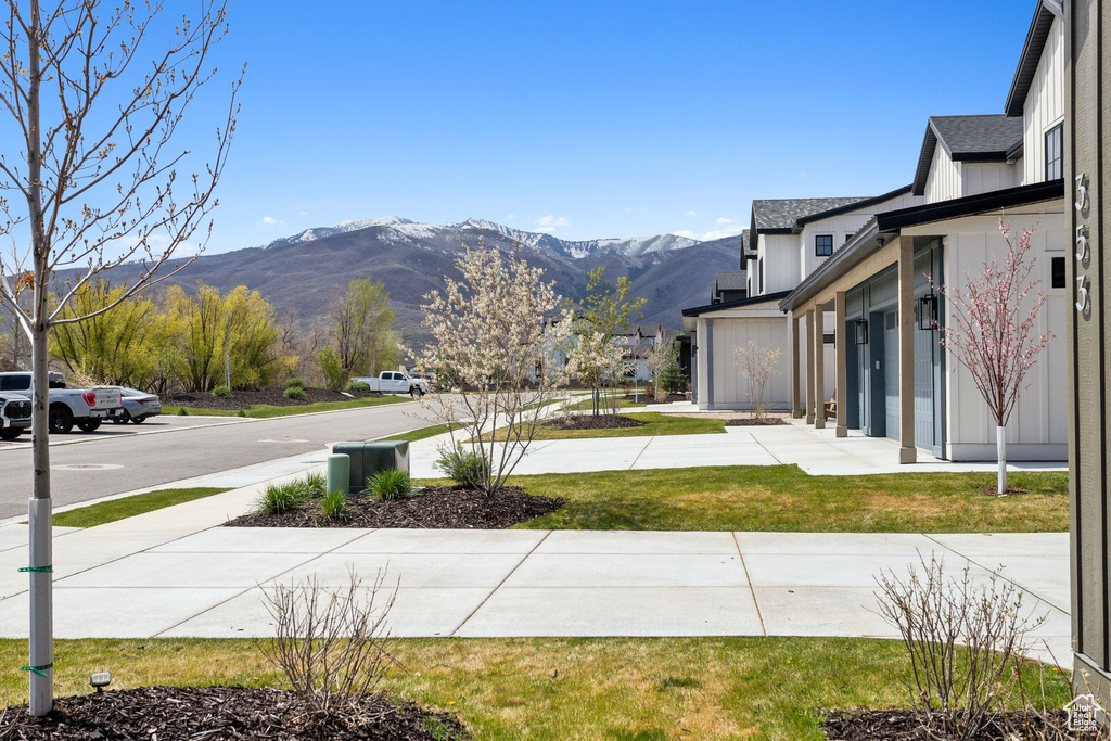 View of green lawn featuring a mountain view