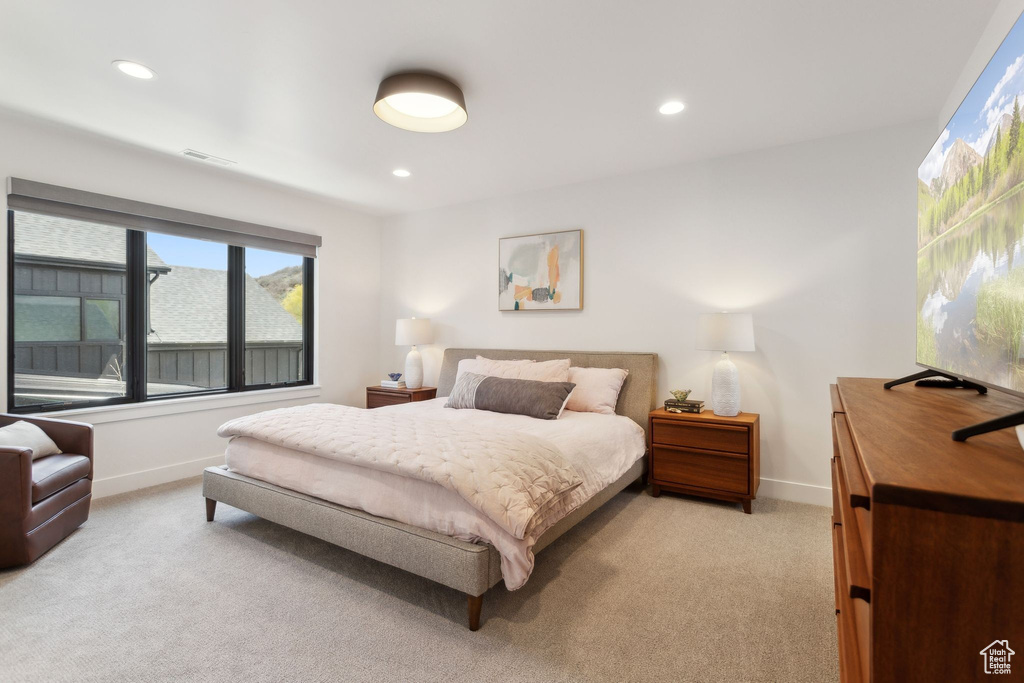 Bedroom with light carpet, baseboards, and recessed lighting