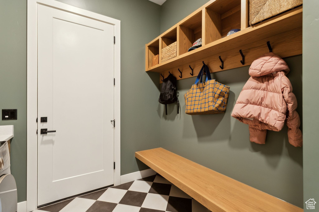 Mudroom featuring tile patterned floors and baseboards