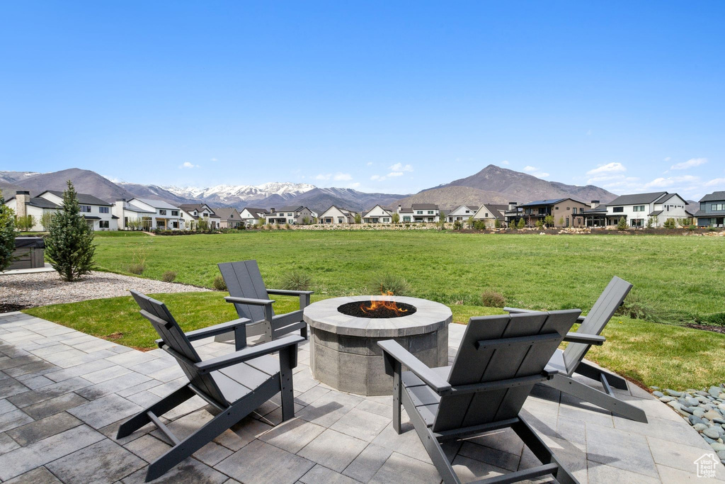 View of patio with a fire pit, a mountain view, and a residential view