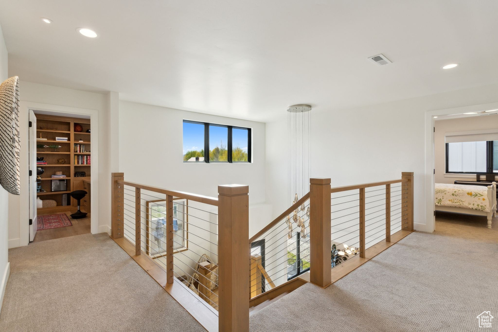Hall featuring carpet floors, an upstairs landing, and recessed lighting