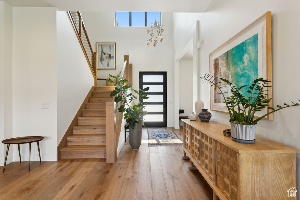 Entryway featuring stairway, hardwood / wood-style flooring, and baseboards