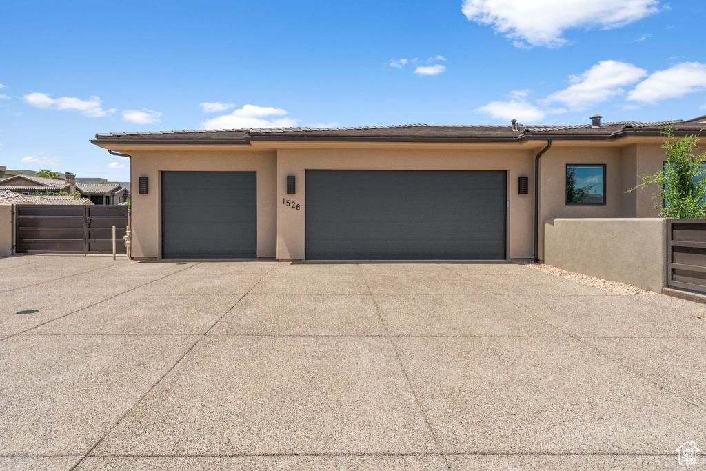 Garage with driveway and fence