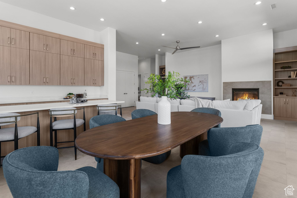 Dining space featuring recessed lighting, a tiled fireplace, and ceiling fan