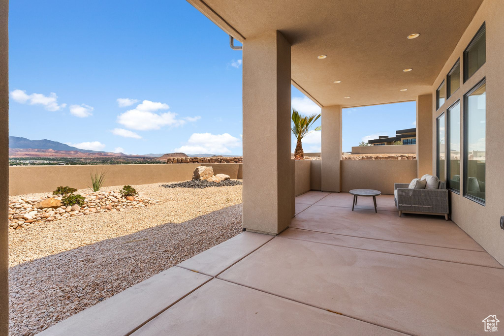 View of patio featuring a mountain view and a fenced backyard