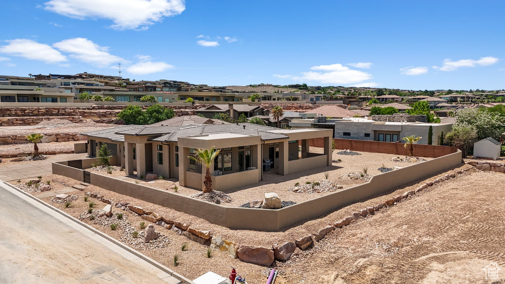 View of front of property with a residential view, fence, and stucco siding