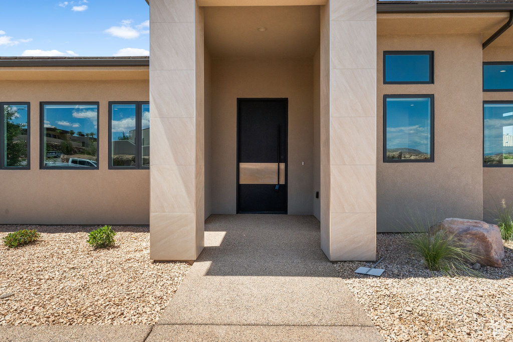 Entrance to property featuring stucco siding