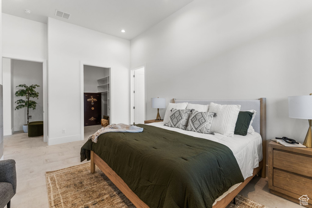 Bedroom featuring a towering ceiling, a spacious closet, recessed lighting, and a closet