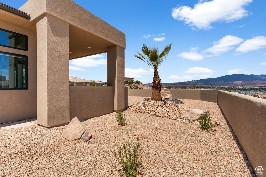 View of yard featuring a mountain view and fence