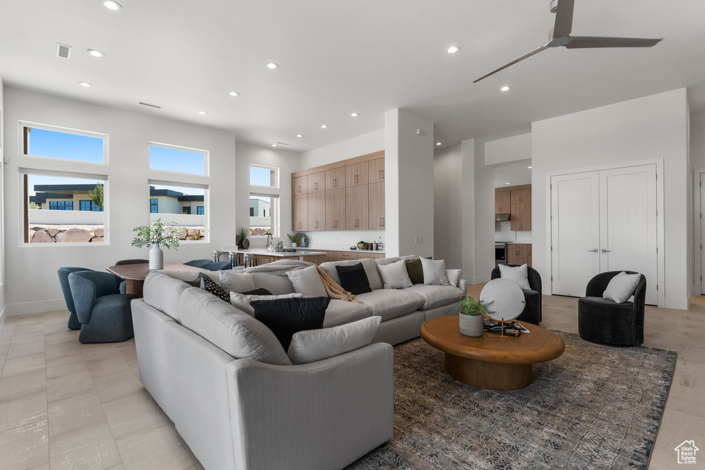 Living room with recessed lighting, a ceiling fan, and baseboards