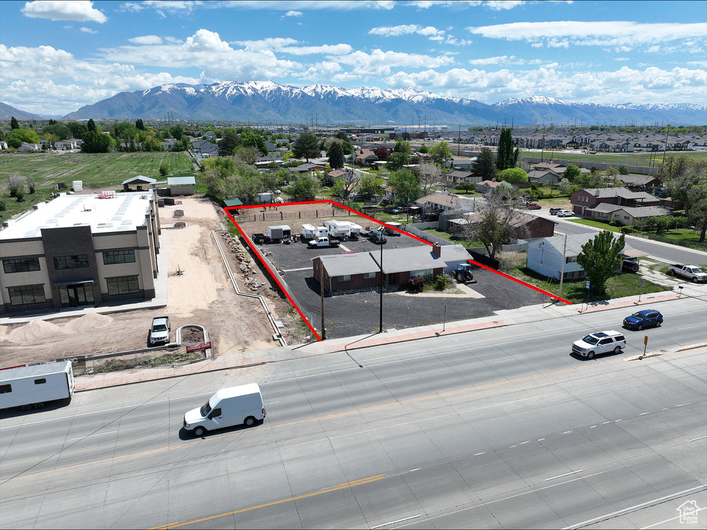 Aerial overview of property\'s location featuring a mountainous background and property parcel outlined
