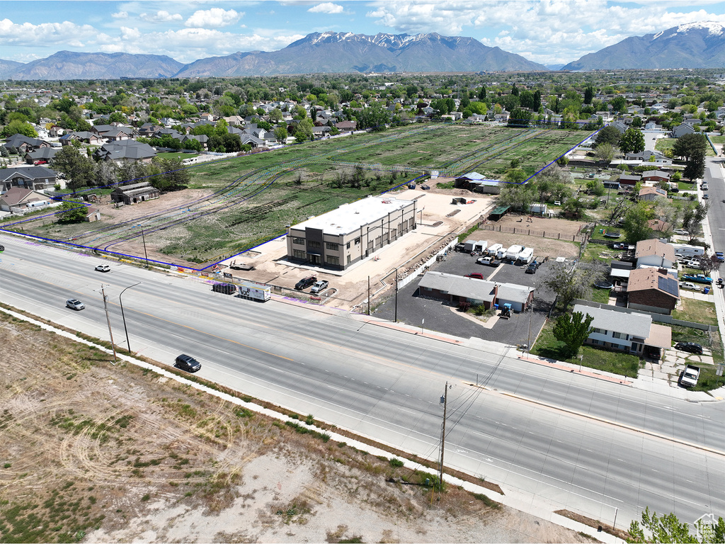 Aerial perspective of suburban area with mountains and property parcel outlined